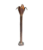 An unusual palm tree floor lamp with real palm trunk, wooden base and wooden shaped leaves