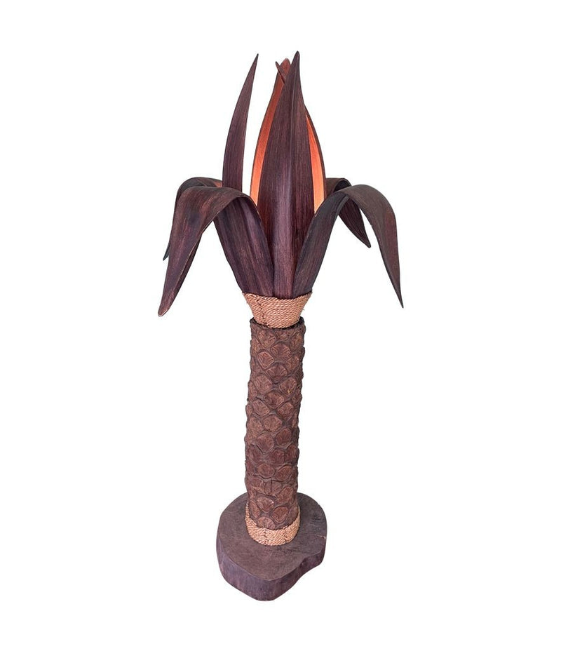 An unusual palm tree floor lamp with real palm trunk wooden base and wooden shaped leaves