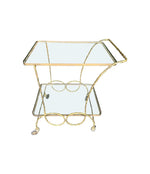 A pretty French 1950s solid brass faux bamboo bar trolley by Maison Baques with two glass shelves