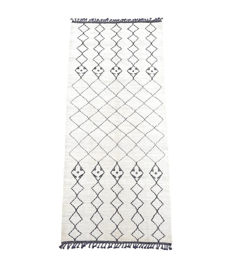 A large handwoven Moroccan Beni Ourain wool berber rug with tribal diamond and line pattern