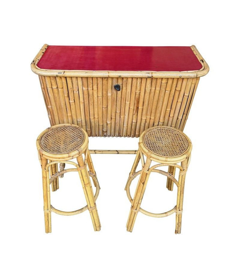 An Italian 1960s bamboo bar cabinet with red laminate top and two stools