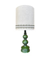 A large French 1960s green glazed ceramic lamp with original hessian shade