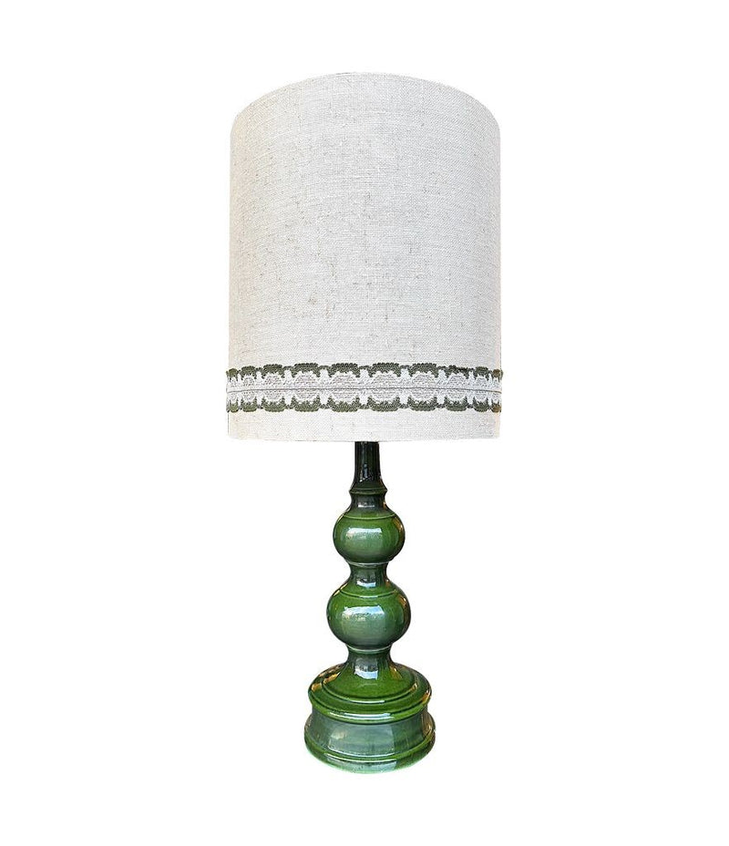 A large French 1960s green glazed ceramic lamp with original hessian shade