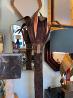 An unusual palm tree floor lamp with real palm trunk, wooden base and wooden shaped leaves