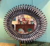 A Spanish 1960s silvered metal landscape or portrait oval eyelash mirror