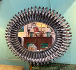A Spanish 1960s silvered metal landscape or portrait oval eyelash mirror