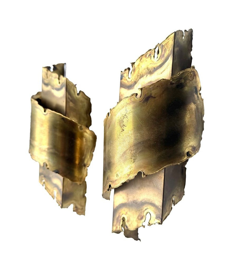 A pair of Danish 1960s torch cut brass wall sconces by Holm Sorensen.