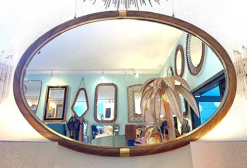 A large oval Italian 1970s twisted rattan and brass mirror in the style of Gabriella Crespi