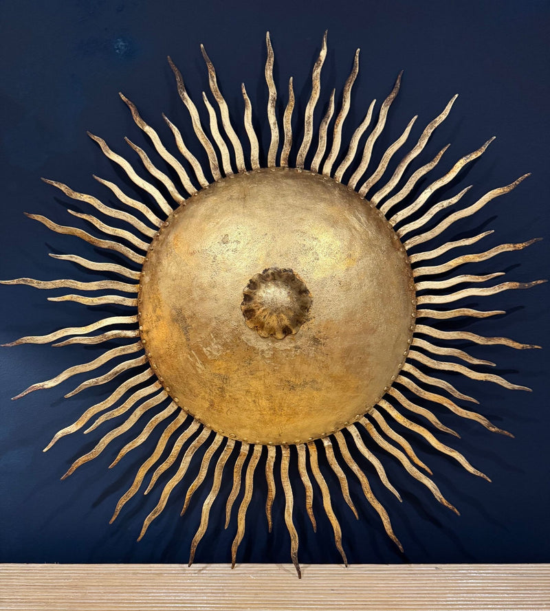 A pair of large 1950s Spanish sunburst wrought iron wall sconces