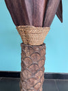 An unusual palm tree floor lamp with real palm trunk, wooden base and wooden shaped leaves