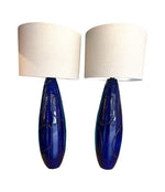 A pair of Italian 1980s large blue ceramic and brass lamps, rewired with with new fittings and linen shades