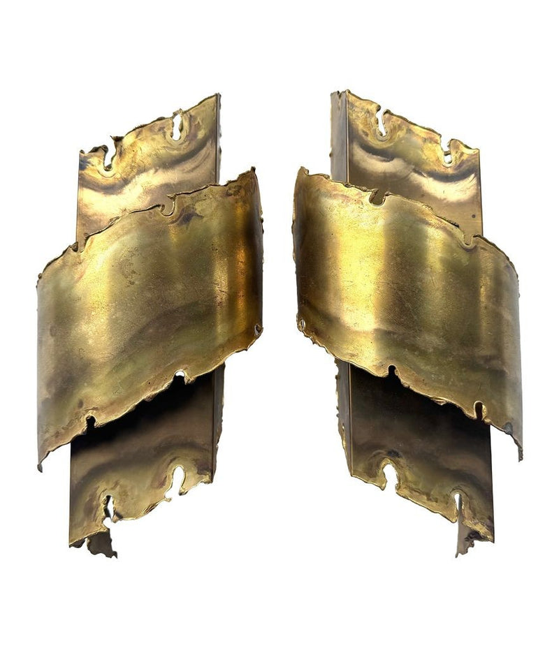 A pair of Danish 1960s torch cut brass wall sconces by Holm Sorensen.