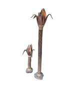 An unusual palm tree floor lamp with real palm trunk wooden base and wooden shaped leaves