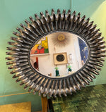 A Spanish 1960s silvered metal landscape or portrait oval eyelash mirror