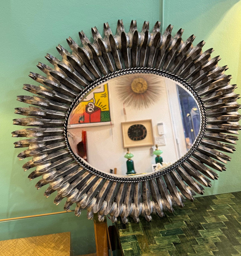 A Spanish 1960s silvered metal landscape or portrait oval eyelash mirror