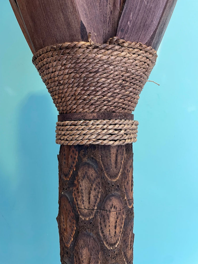 An unusual palm tree floor lamp with real palm trunk, wooden base and wooden shaped leaves