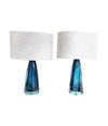 A pair of 1960s Orrefors turquoise glass and brass lamps with new bespoke linen shades