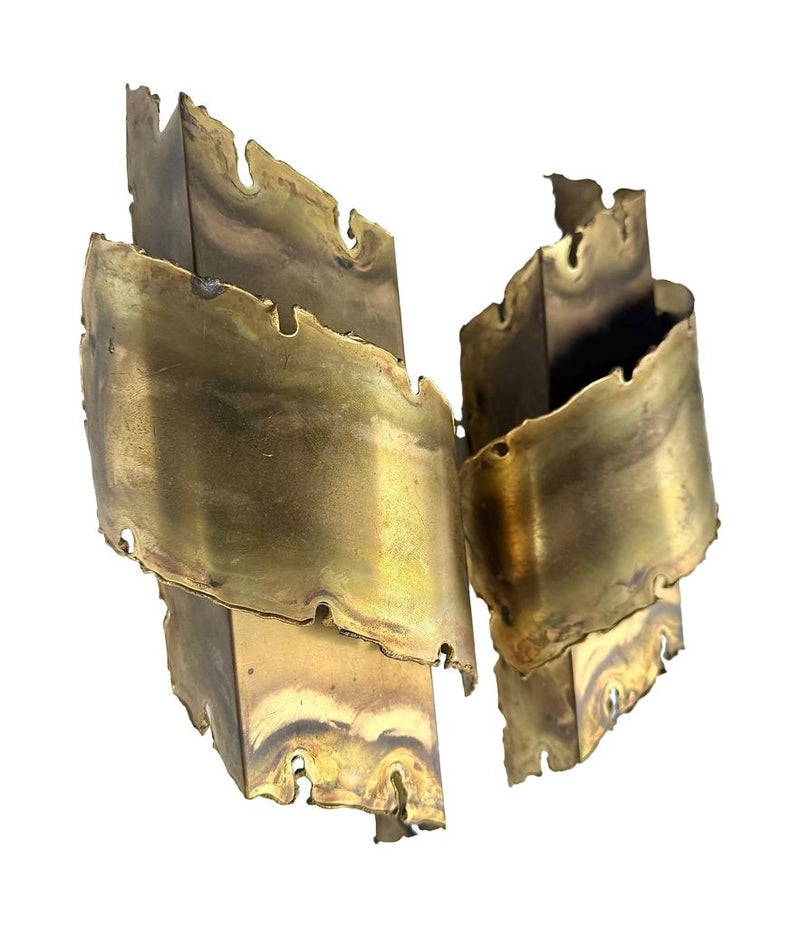 A pair of Danish 1960s torch cut brass wall sconces by Holm Sorensen.