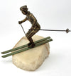 A large pair of bronze cast skiers by Curtis Jere mounted on onyx slabs