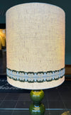 A large French 1960s green glazed ceramic lamp with original hessian shade