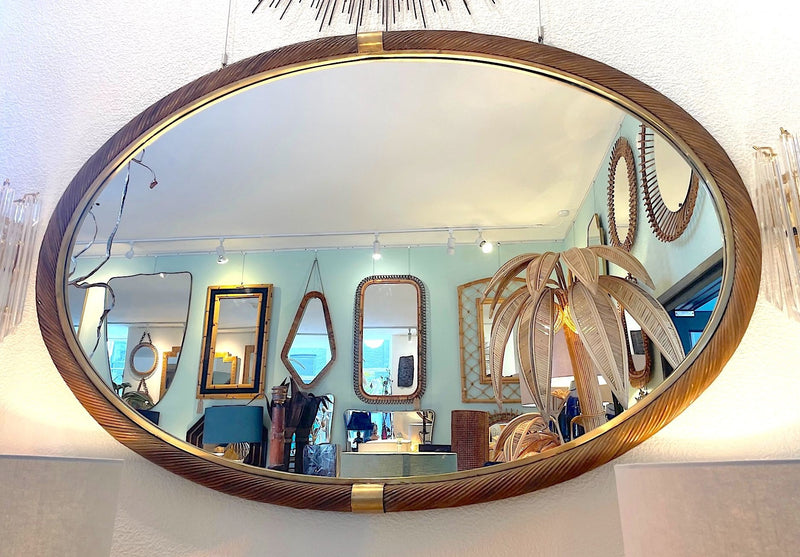 A large oval Italian 1970s twisted rattan and brass mirror in the style of Gabriella Crespi