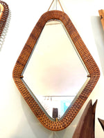 An unusual Italian 1950s diamond shaped woven rattan and brass framed mirror with leather hanging strap