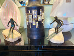 A large pair of bronze cast skiers by Curtis Jere mounted on onyx slabs