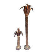 An unusual palm tree floor lamp with real palm trunk wooden base and wooden shaped leaves