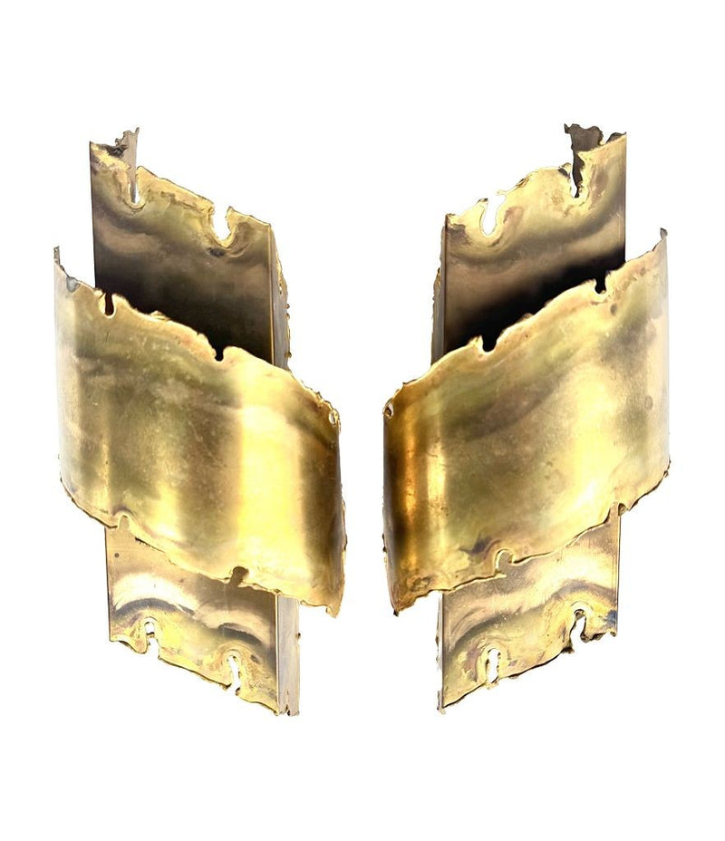 A pair of Danish 1960s torch cut brass wall sconces by Holm Sorensen.