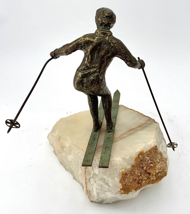 A large pair of bronze cast skiers by Curtis Jere mounted on onyx slabs