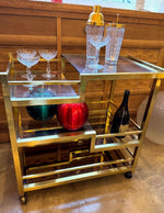 Mid century Romeo Rega Italian gilt metal bar trolley with smoked glass shelves