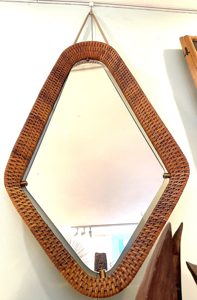 An unusual Italian 1950s diamond shaped woven rattan and brass framed mirror with leather hanging strap