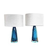 A pair of 1960s Orrefors turquoise glass and brass lamps with new bespoke linen shades