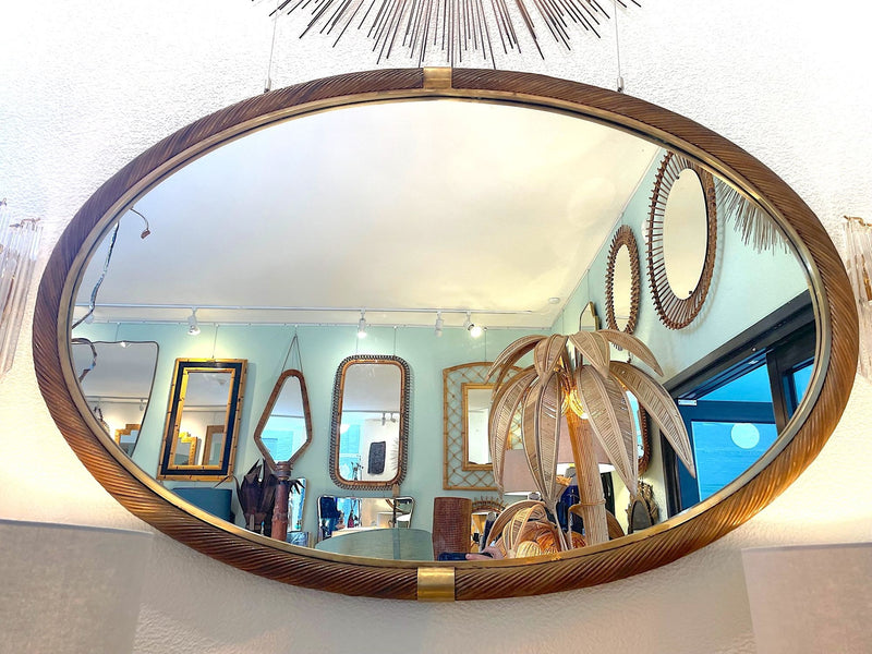 A large oval Italian 1970s twisted rattan and brass mirror in the style of Gabriella Crespi