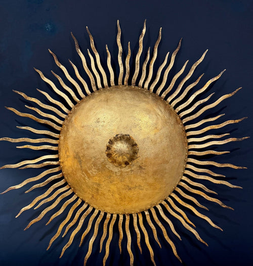 A pair of large 1950s Spanish sunburst wrought iron wall sconces