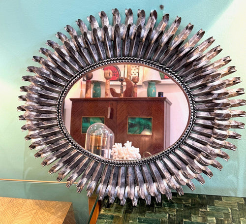 A Spanish 1960s silvered metal landscape or portrait oval eyelash mirror