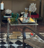 A pair of 1950s gilt wrought iron French side tables, with glass shelves