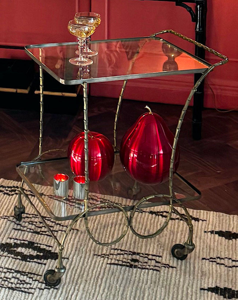 A pretty French 1950s solid brass faux bamboo bar trolley by Maison Baques with two glass shelves