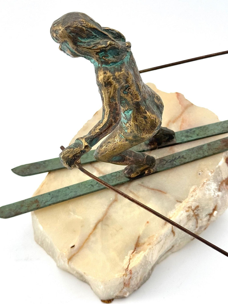 A large pair of bronze cast skiers by Curtis Jere mounted on onyx slabs