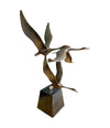 A French 1960s Mid century bronze sculpture by Lumiere of three flying swans mounted on a bronze base,