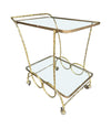 A pretty French 1950s solid brass faux bamboo bar trolley by Maison Baques with two glass shelves