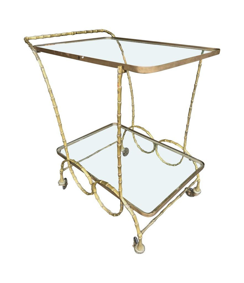 A pretty French 1950s solid brass faux bamboo bar trolley by Maison Baques with two glass shelves