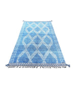 A good quality handmade Morrocan Beni Ourain with white tribal diamond and line pattern on blue background