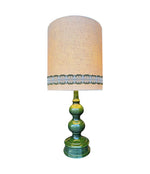 A large French 1960s green glazed ceramic lamp with original hessian shade