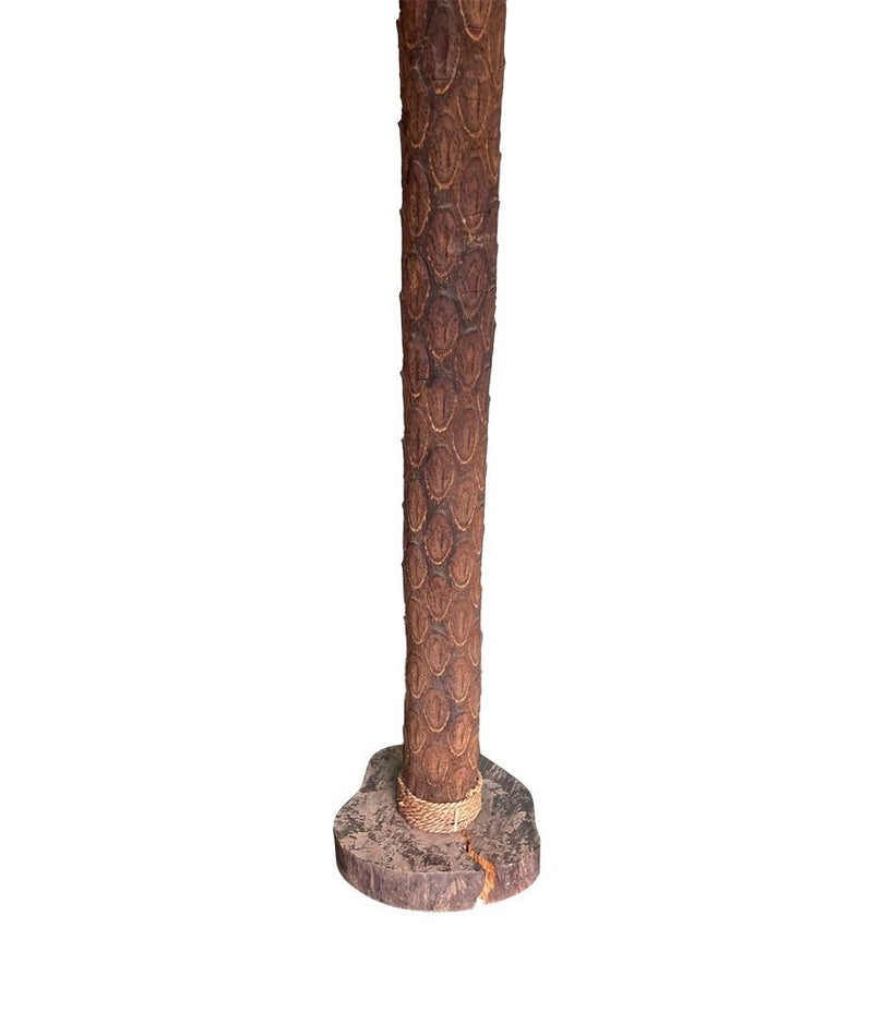 An unusual palm tree floor lamp with real palm trunk, wooden base and wooden shaped leaves