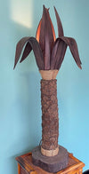 An unusual palm tree floor lamp with real palm trunk wooden base and wooden shaped leaves