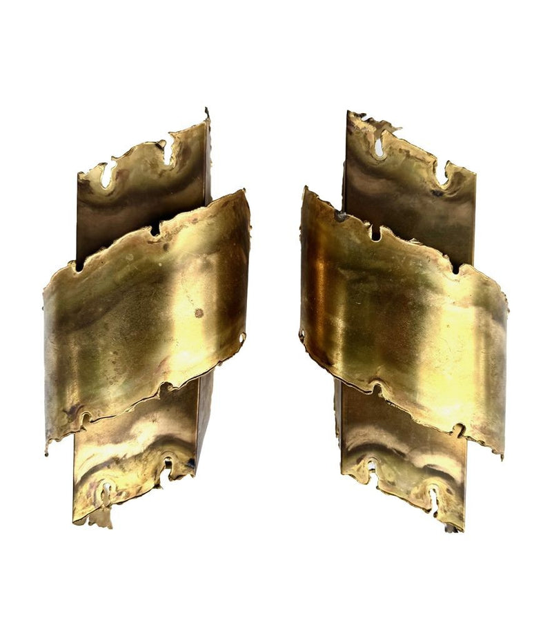 A pair of Danish 1960s torch cut brass wall sconces by Holm Sorensen.