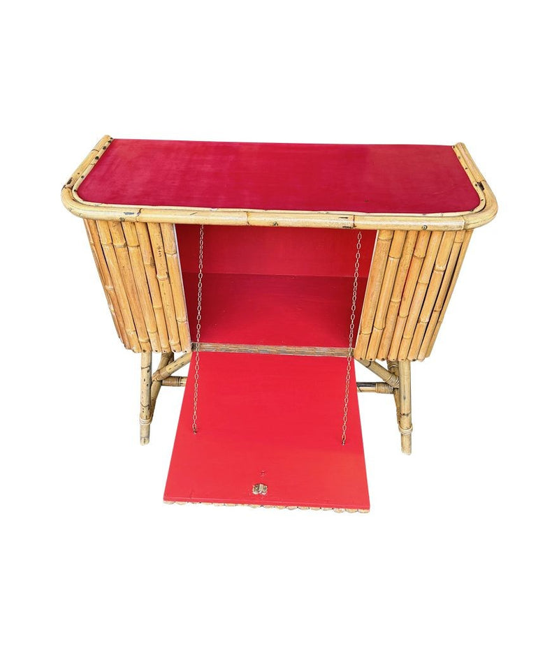 An Italian 1960s bamboo bar cabinet with red laminate top and two stools