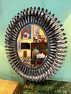 A Spanish 1960s silvered metal landscape or portrait oval eyelash mirror