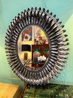 A Spanish 1960s silvered metal landscape or portrait oval eyelash mirror